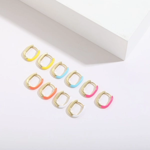 Close-up of five pairs colorful U-shaped enamel hoop earrings in 14K gold plated finish