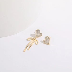 Minimalist 14K gold plated asymmetrical heart earrings with crystal bow tie detail