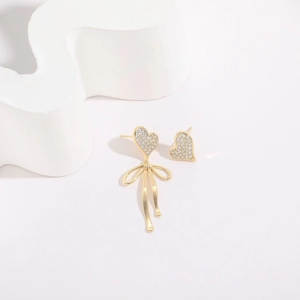 Minimalist asymmetric heart bow earrings in 14K gold plating with shimmering zircons