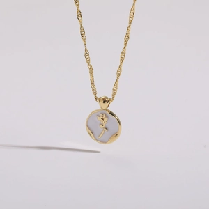 Detail of 14K gold plated rose coin necklace with lavender enamel and hammered texture