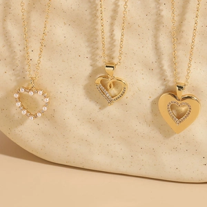 Three elegant heart necklaces in 14K gold plated finish with pearls and zircon stones