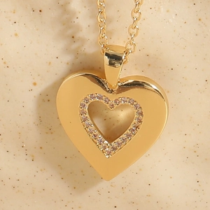 Detailed view of heart-shaped pendant with pavé cubic zirconia and 14K gold plated chain