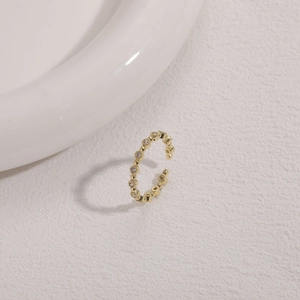 Detailed macro of minimalist 14K gold plated beaded ring featuring sparkling zircon inlay