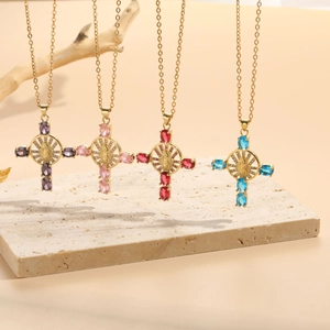 Detailed macro view of four colorful zircon cross necklaces with Virgin Mary relief on stone