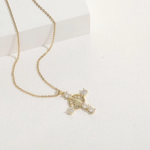Detailed close-up of 14K gold plated cross pendant with zircons and Mary icon