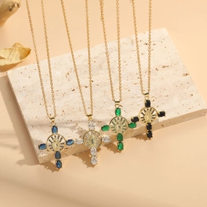 Detailed close-up of four luxury cross necklaces with colorful zircon stones in gold finish
