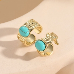 Set of two gold plated turquoise rings with irregular hammer texture and adjustable open band