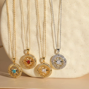 Detail of compass necklaces with zircon insets and I'd be lost without you engraving