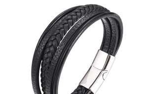 Detail of multi-layer black braided leather bracelet with silver magnetic steel clasp