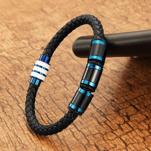 Detailed close-up of blue and black braided leather bracelet with stainless steel magnetic clasp