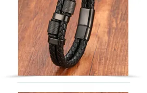 Macro detail of black braided leather men's bracelet with textured knurled metal clasp
