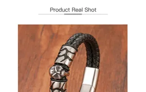 Close-up of leather braided bracelet featuring a skull charm and polished metal clasp