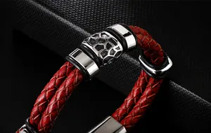 Dettaglio del bracciale in pelle intrecciata rossa e nera con chiusura in metallo argentato