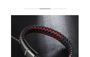 Macro shot of black braided microfiber leather bracelet with red stitching and metal clasp