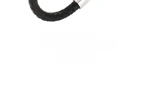 Macro shot of a braided black leather bracelet featuring a polished silver metal buckle