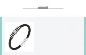 Macro shot of men's black braided leather bracelet featuring vintage engraved metal charms
