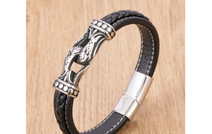 Macro detail of men's braided leather bracelet with vintage silver metal clasp