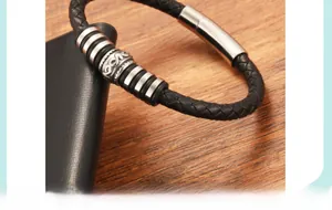 Close-up of black braided leather bracelet with vintage silver bead and metal buckle