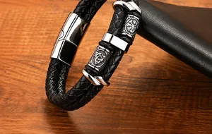 Close-up of men's black braided leather bracelet with Celtic knot magnetic steel clasp
