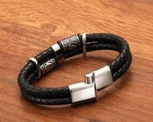 Detailed close-up of men's double-layer braided black leather bracelet with carved beads