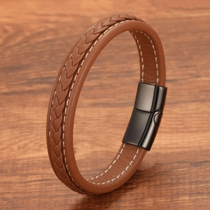 Detail shot of brown woven leather bracelet with hand-stitched seams and matte black clasp