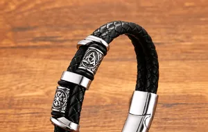 Detailed close-up of men's double-layer black leather bracelet with Viking metal beads