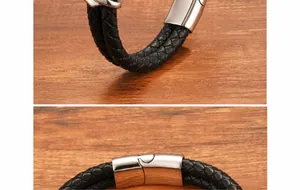 Detail of black braided leather men's bracelet with polished stainless steel clasp