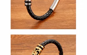 Dettaglio di bracciali in pelle nera intrecciata con chiusure in metallo incise argento e oro