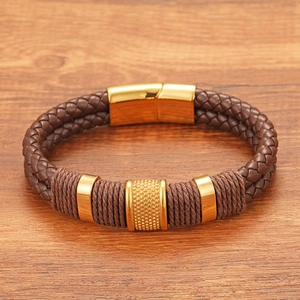 Detail of a brown double-layer braided leather bracelet with a gold magnetic clasp