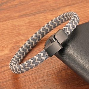 Bracelet tressé en cuir pour homme avec fermoir magnétique noir mat sur fond de bois