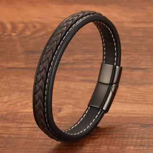 Men's minimalist braided leather bracelet with magnetic steel clasp on wood background