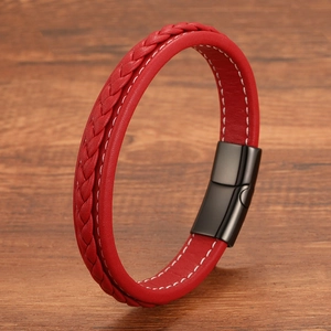 Red braided leather bracelet for men with black matte magnetic clasp on wood background