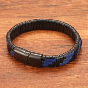 Detail of multi-layer black and blue leather braid with black magnetic clasp on wood
