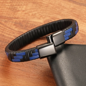 Detail of multi-layered black and blue woven leather bracelet with a black magnetic clasp