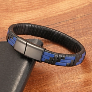 Detailed macro of a woven leather bracelet with matte black magnetic metal clasp