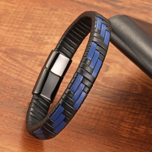Detail of multi-layer black and blue braided leather bracelet with black magnetic buckle