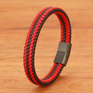 Minimalist braided leather bracelet with matte black magnetic buckle on wood surface