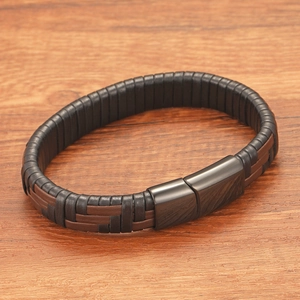 Close-up of the woven leather texture and black magnetic clasp on a punk style bracelet
