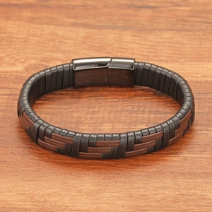 Detail view of woven leather layers and black magnetic clasp on a punk style bracelet