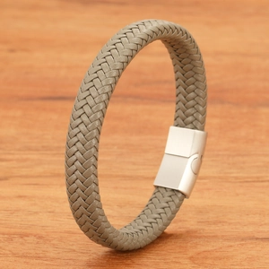 Detailed view of sixteen-strand braided grey leather bracelet with brushed metal magnetic clasp
