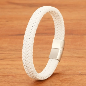 Detailed close-up of a white braided leather bracelet with a matte silver magnetic clasp