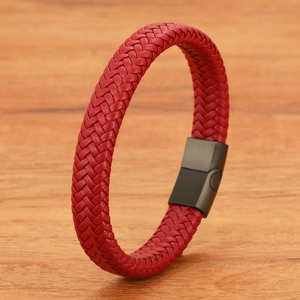 Detail of red braided leather cord bracelet with matte black magnetic metal clasp