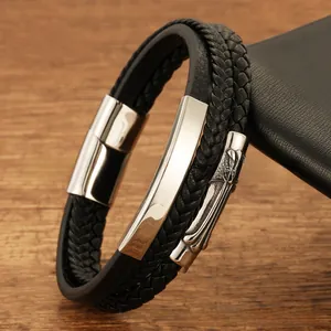 Detail view of men's multi-layer black braided leather bracelet with silver cross element