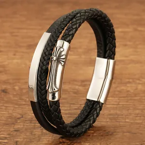 Detail of multi-layer black leather bracelet with silver cross relief and magnetic clasp