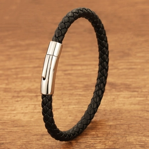 Detailed close-up of a black braided leather bracelet with a polished silver magnetic clasp