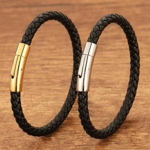 Detailed macro view of woven leather bracelets featuring silver and gold magnetic clasps