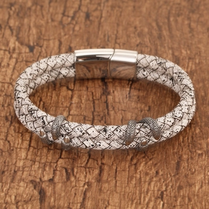 Detail of vintage dragon claw bracelets with braided leather and magnetic steel clasp