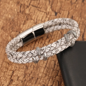 Retro woven leather dragon claw bracelet with a silver magnetic buckle on dark background