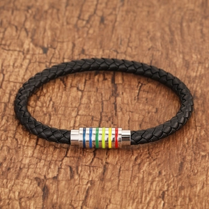 Macro detail of braided leather bracelet featuring a colorful rainbow magnetic metal clasp