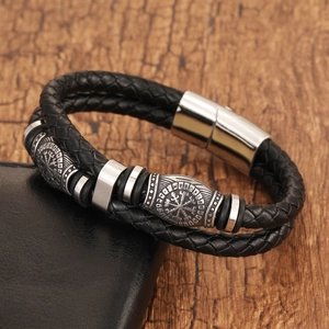 Detail of Viking Vegvisir compass charm on double-layer braided black leather bracelet